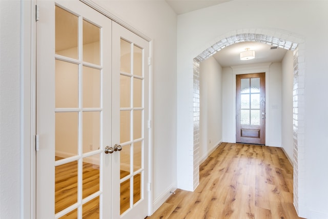 doorway to outside featuring french doors and light hardwood / wood-style flooring