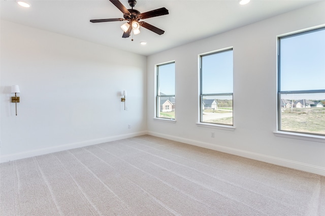 carpeted spare room featuring baseboards, a ceiling fan, and recessed lighting