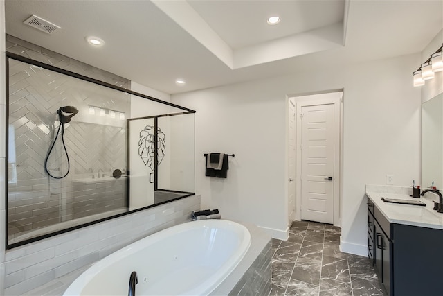 bathroom with tile flooring, separate shower and tub, vanity, and a raised ceiling