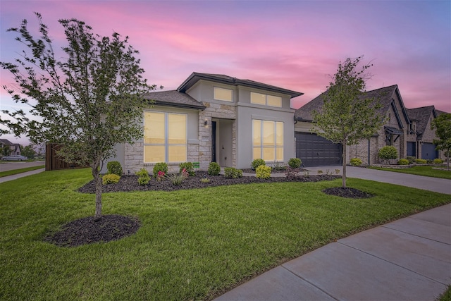 view of front facade with a garage and a lawn