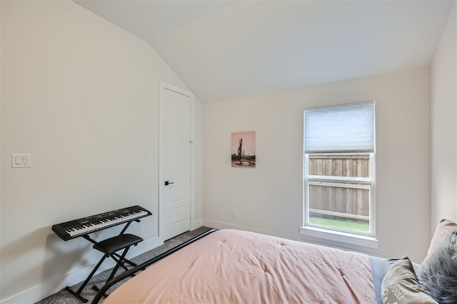 bedroom featuring carpet flooring and vaulted ceiling