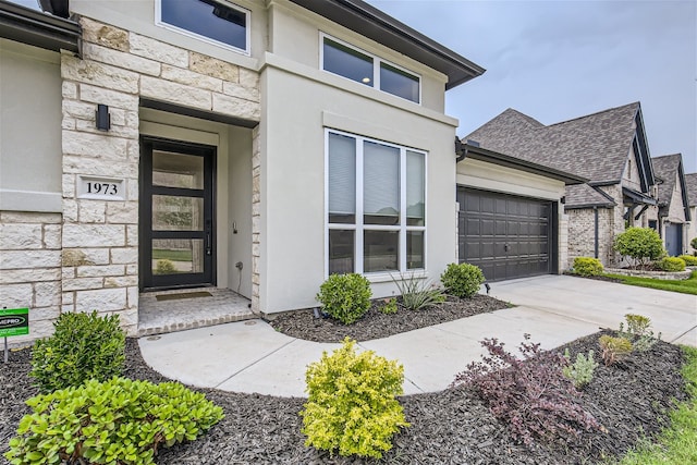 doorway to property with a garage