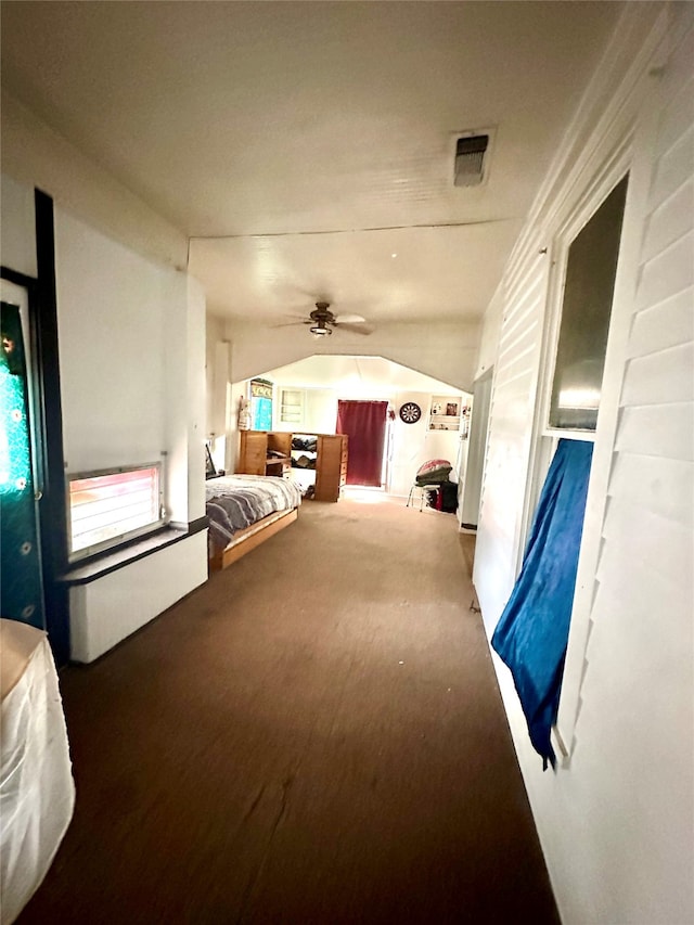 interior space with ceiling fan and vaulted ceiling