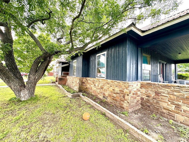 view of side of property with a yard