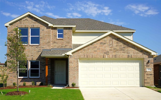 view of front of home with a garage and a front lawn