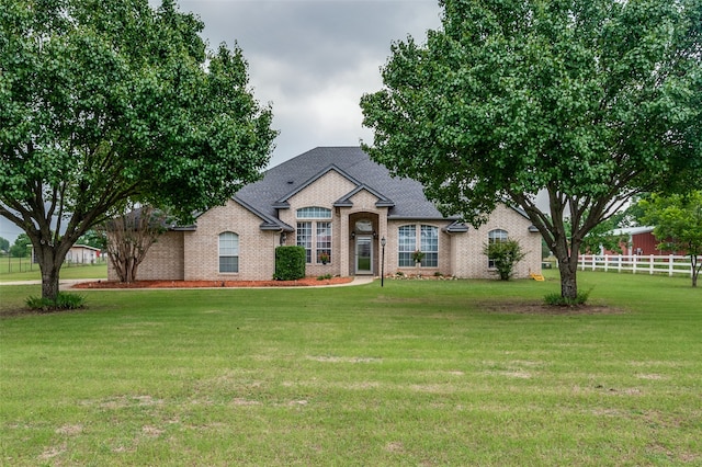 french country style house with a front yard