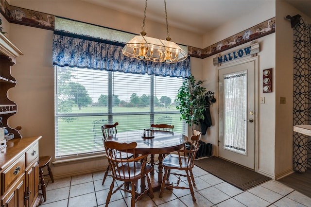 dining room featuring plenty of natural light, a notable chandelier, and light tile floors