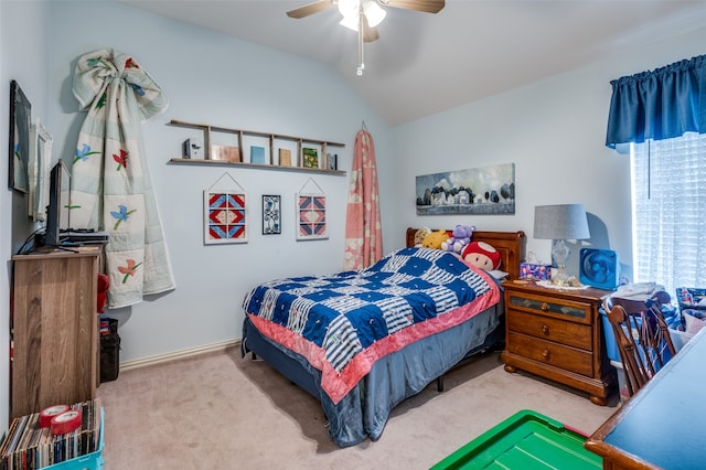 carpeted bedroom featuring ceiling fan and vaulted ceiling