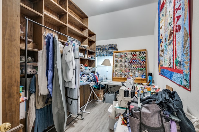 walk in closet with light hardwood / wood-style floors