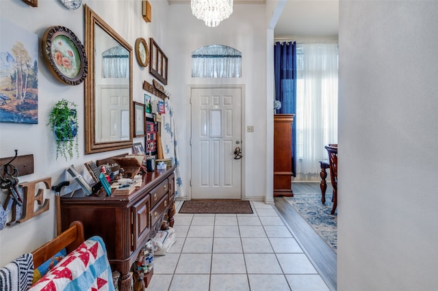 foyer featuring a notable chandelier and light tile flooring