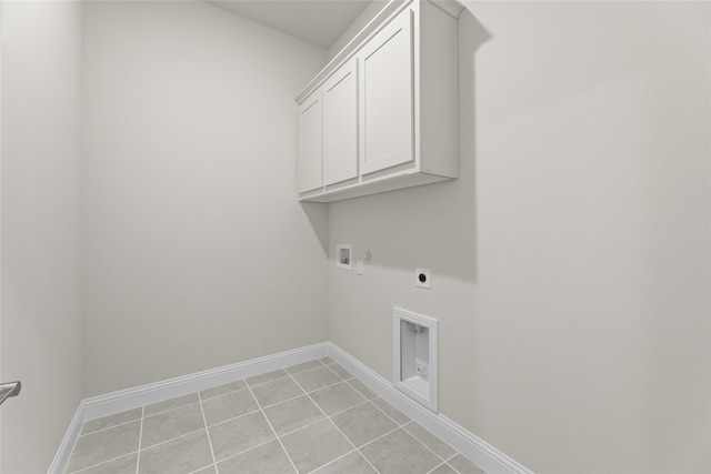 laundry area with cabinets, hookup for a washing machine, hookup for an electric dryer, light tile patterned floors, and gas dryer hookup