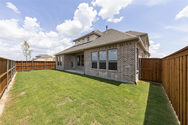 rear view of property with a patio and a lawn