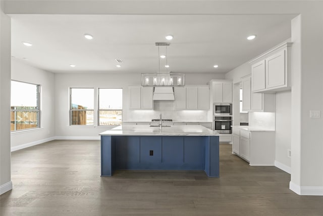 kitchen featuring backsplash, appliances with stainless steel finishes, a healthy amount of sunlight, and wood-type flooring