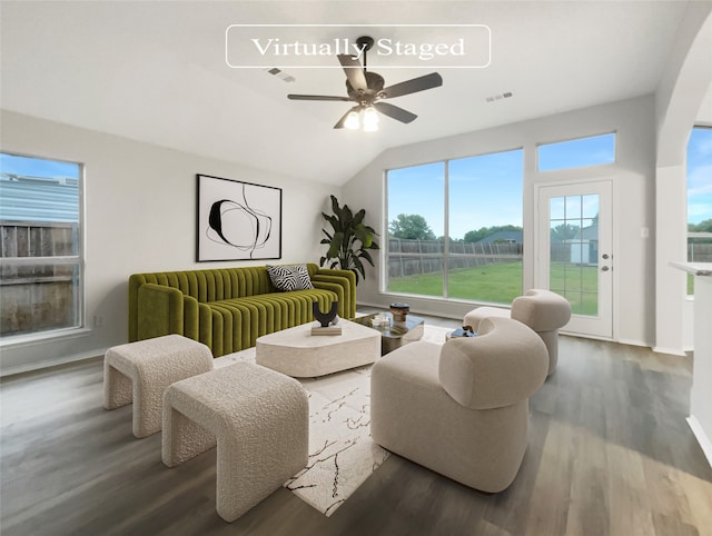 living room with dark wood-type flooring, ceiling fan, and lofted ceiling