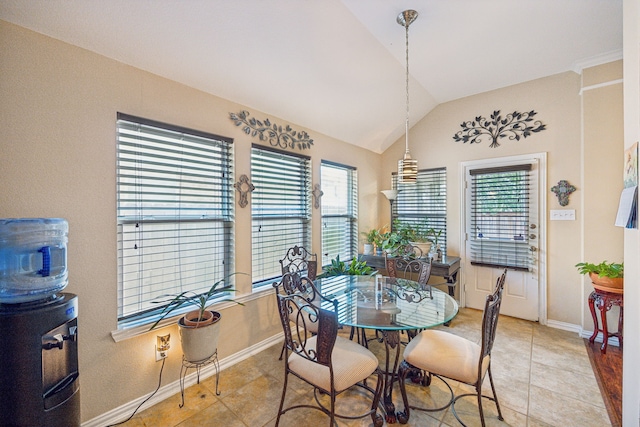 tiled dining space featuring a wealth of natural light and lofted ceiling