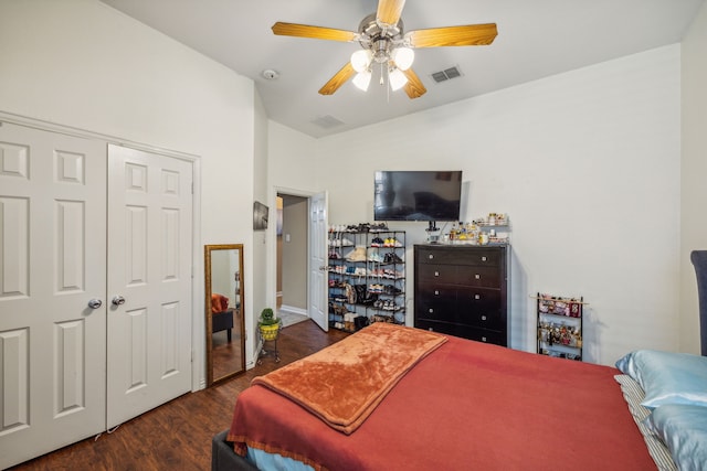 bedroom featuring vaulted ceiling, dark hardwood / wood-style flooring, a closet, and ceiling fan