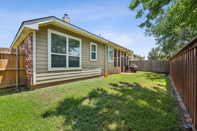 back of property featuring a yard