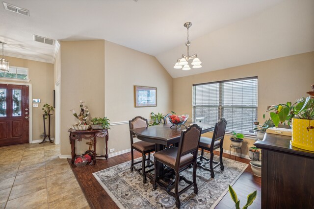 dining space featuring an inviting chandelier and tile flooring