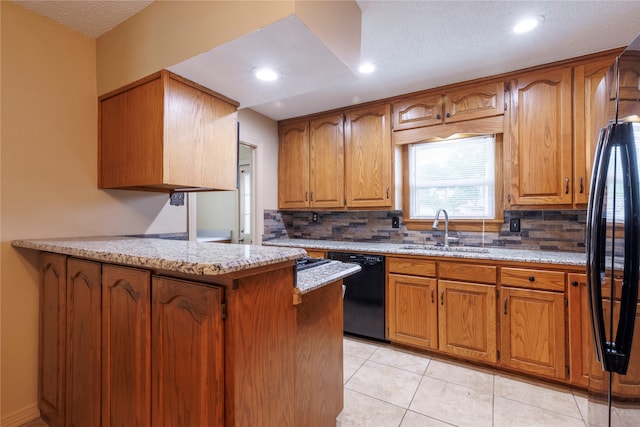 kitchen with sink, dishwasher, backsplash, and light tile floors