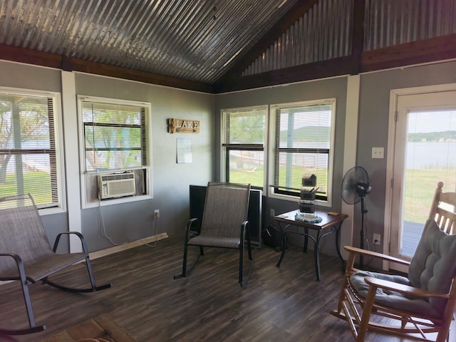 sitting room with cooling unit, dark wood-type flooring, plenty of natural light, and vaulted ceiling