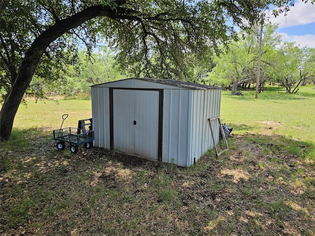 view of outbuilding with a lawn