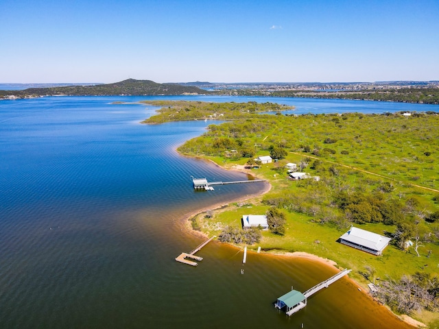 drone / aerial view featuring a water and mountain view