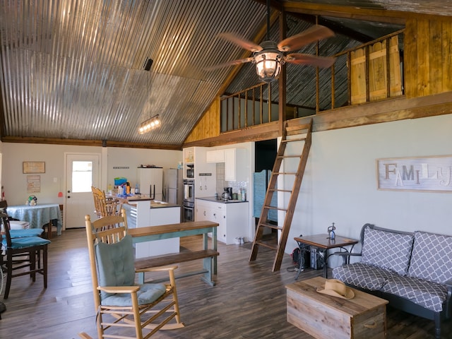 dining room featuring ceiling fan, high vaulted ceiling, and hardwood / wood-style floors