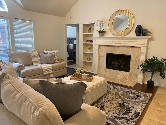 tiled living room with lofted ceiling, built in shelves, and a fireplace