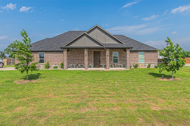 view of front of house with a patio area and a front lawn