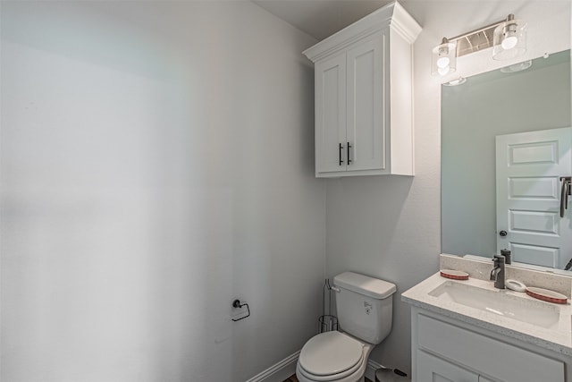 bathroom featuring oversized vanity and toilet