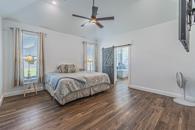 bedroom with ceiling fan, hardwood / wood-style flooring, a barn door, ensuite bathroom, and lofted ceiling