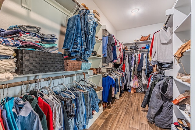 walk in closet with hardwood / wood-style flooring