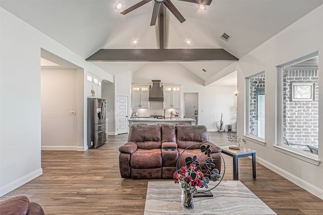 living room featuring ceiling fan, lofted ceiling with beams, and hardwood / wood-style floors