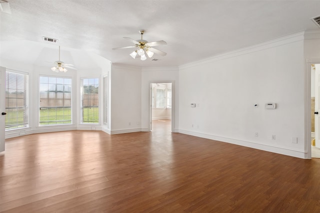 unfurnished room featuring ceiling fan, crown molding, vaulted ceiling, a textured ceiling, and hardwood / wood-style flooring