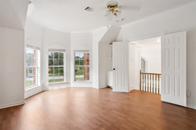 unfurnished room featuring ornamental molding, wood-type flooring, and ceiling fan