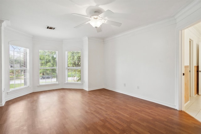 empty room with hardwood / wood-style floors, ceiling fan, and crown molding