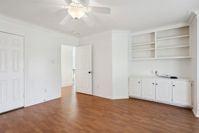 spare room with crown molding, ceiling fan, and hardwood / wood-style floors