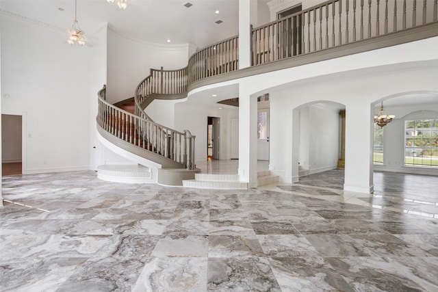 unfurnished living room featuring a high ceiling, tile flooring, and an inviting chandelier