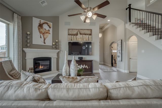 living room featuring vaulted ceiling and ceiling fan