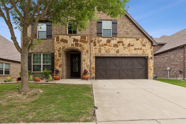 view of front of home with a front yard and a garage