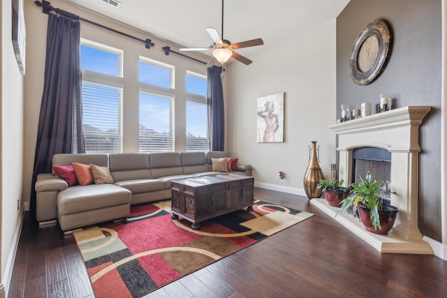 living room with ceiling fan and dark hardwood / wood-style floors