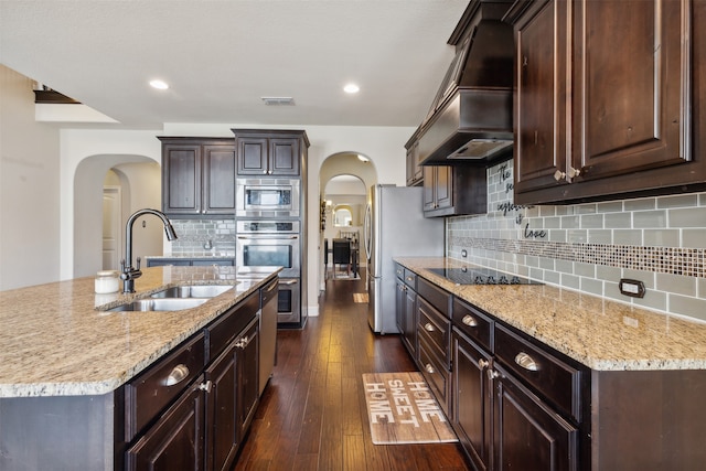 kitchen featuring custom range hood, dark hardwood / wood-style flooring, backsplash, sink, and appliances with stainless steel finishes