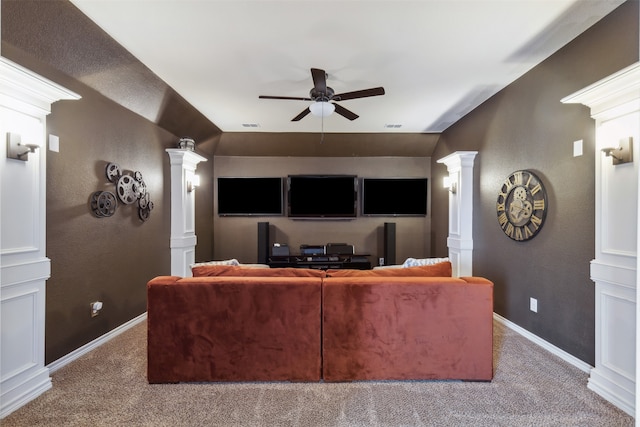 carpeted cinema room with decorative columns and ceiling fan