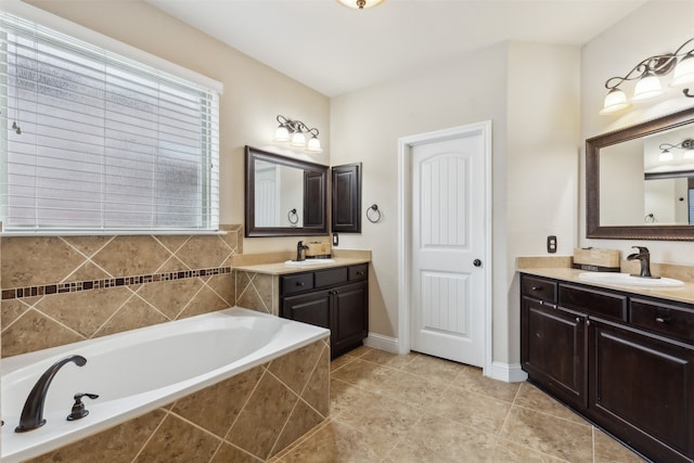 bathroom with tile flooring, tiled bath, and double vanity