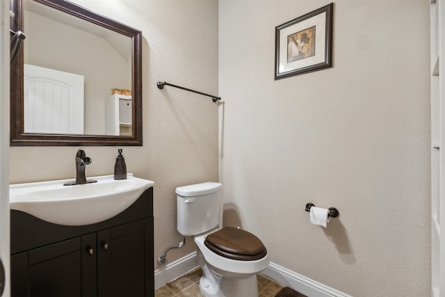 bathroom featuring tile floors, oversized vanity, and toilet