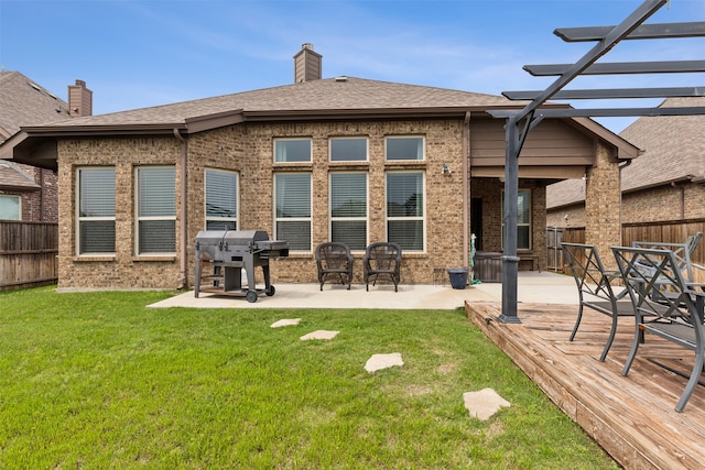 back of property with a yard and a patio area