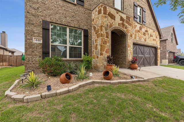 tudor home with a garage and a front yard