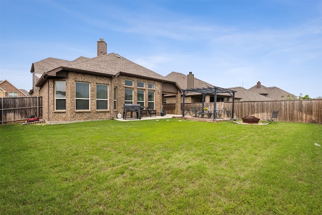 rear view of house with a patio area and a lawn