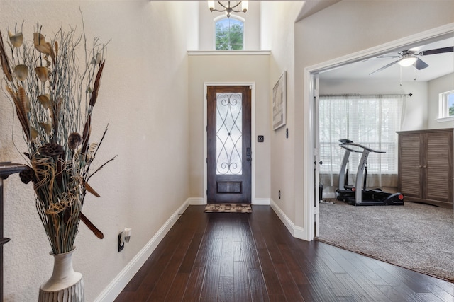 foyer entrance featuring plenty of natural light, ceiling fan, and dark hardwood / wood-style flooring