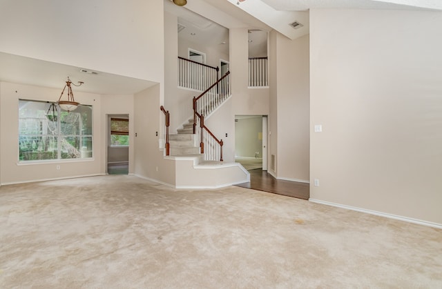 interior space with carpet flooring and a high ceiling